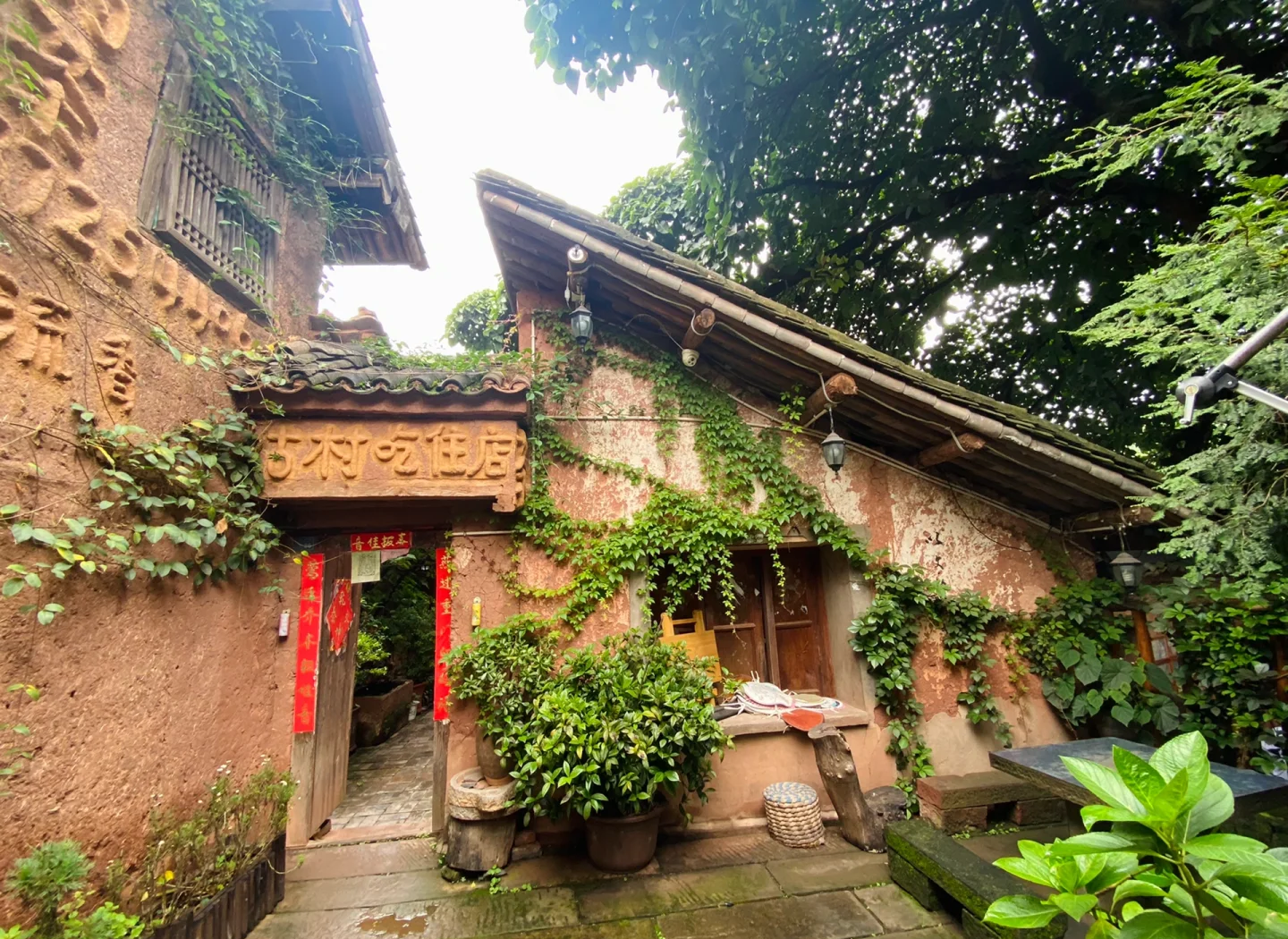 Ancient dwellings in Nuodeng Village, featuring traditional Bai ethnic architectural style with gray tiles, white walls, and carved wooden doors and windows