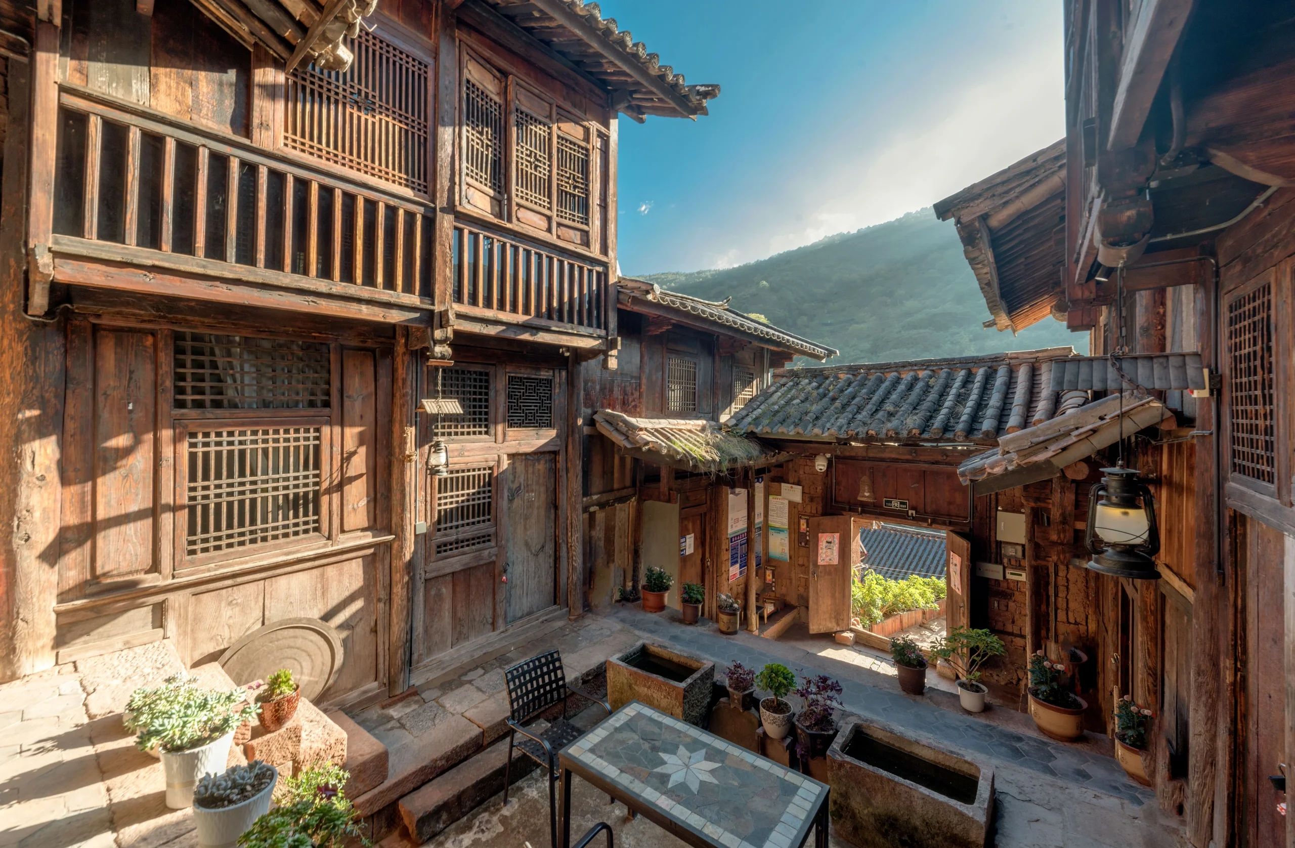 Stone paths in Nuodeng Ancient Village with primitive Bai ethnic houses on both sides and winding stone steps